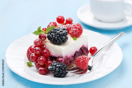 dessert - a piece of cake with fresh berries on blue background