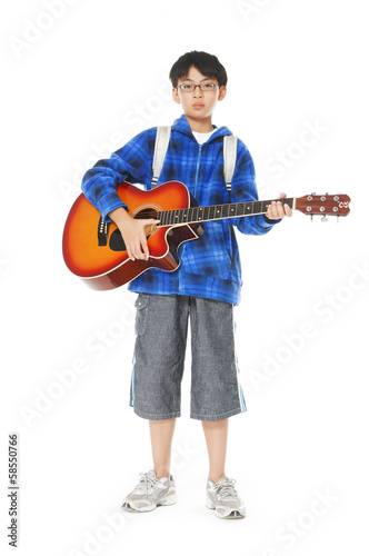 Portrait of a young boy holding a classical guitar