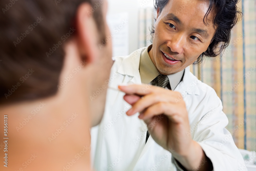 Doctor Examining Male Patient's Mouth Doctor Examining Male Patient's Mouth