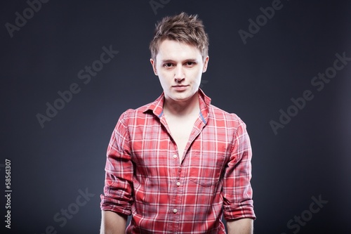 Portrait of casual young man in red checkered shirt