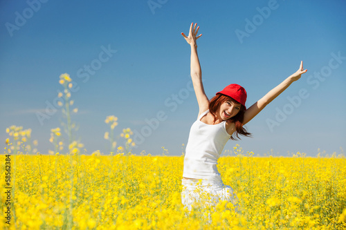 Happy woman in the field with flowers