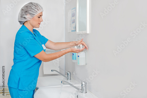 Beautiful nurse wiped his hands dry photo