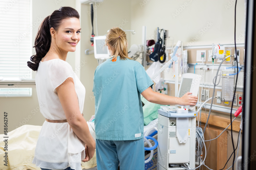 Woman With Nurse Examining Patient In Hospital Woman With Nurse Examining Patient In Hospital