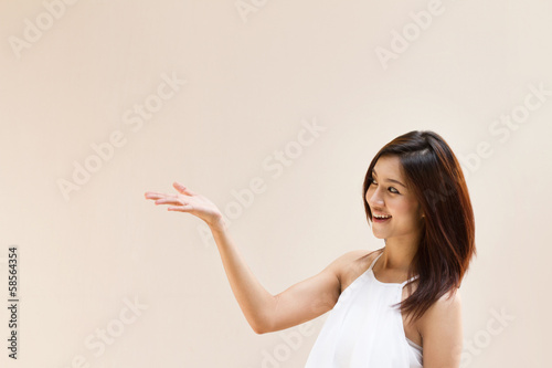 woman hand holding blank space on plain warm tone background