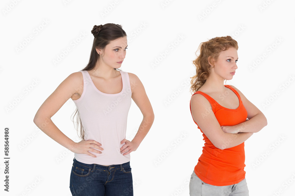 Unhappy young female friends not talking after argument Unhappy young female friends not talking after argument