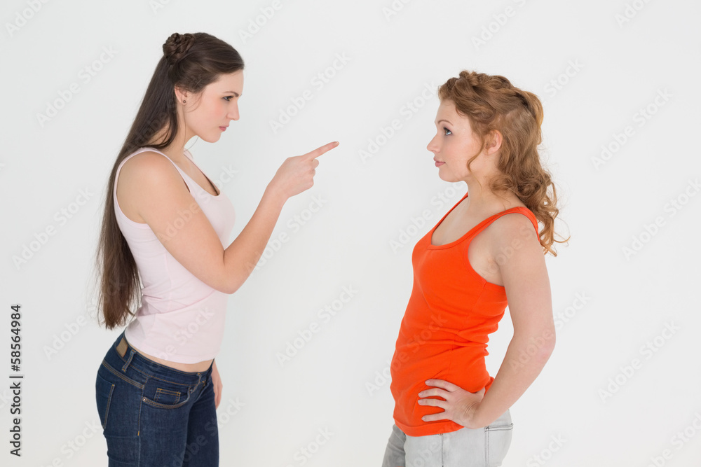 Angry young female friends having an argument Angry young female friends having an argument