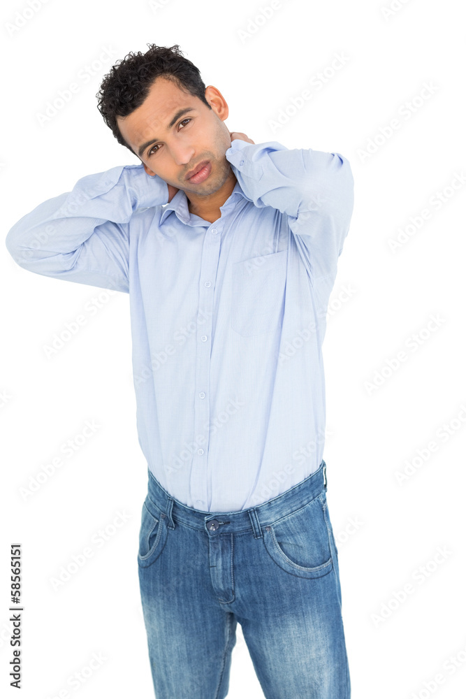 Portrait of a young man suffering from neck ache Portrait of a young man suffering from neck ache