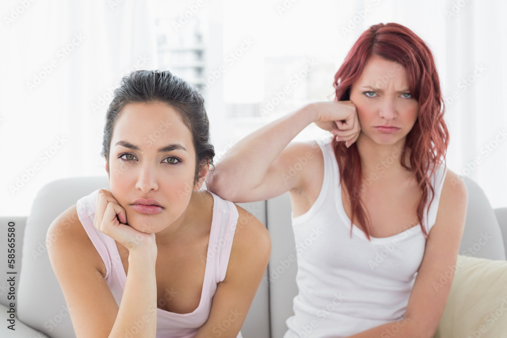 Unhappy female friends not talking after argument at home Unhappy female friends not talking after argument at home