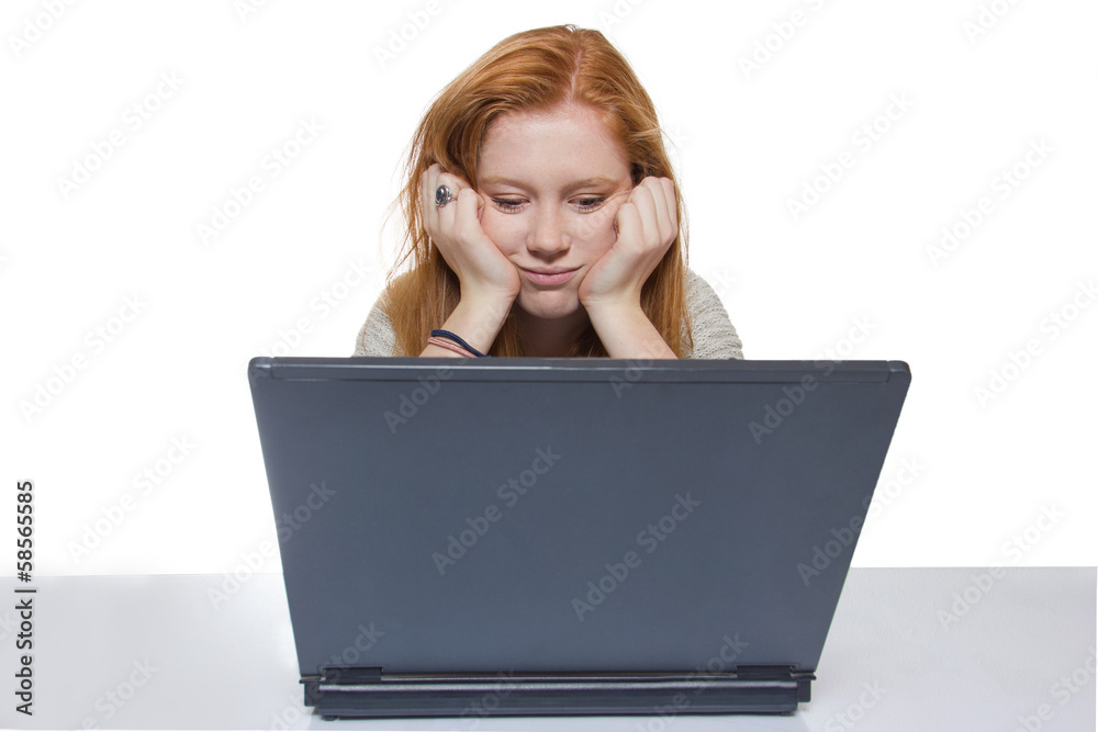 Young girl sitting in front of her notebook Young girl sitting in front of her notebook