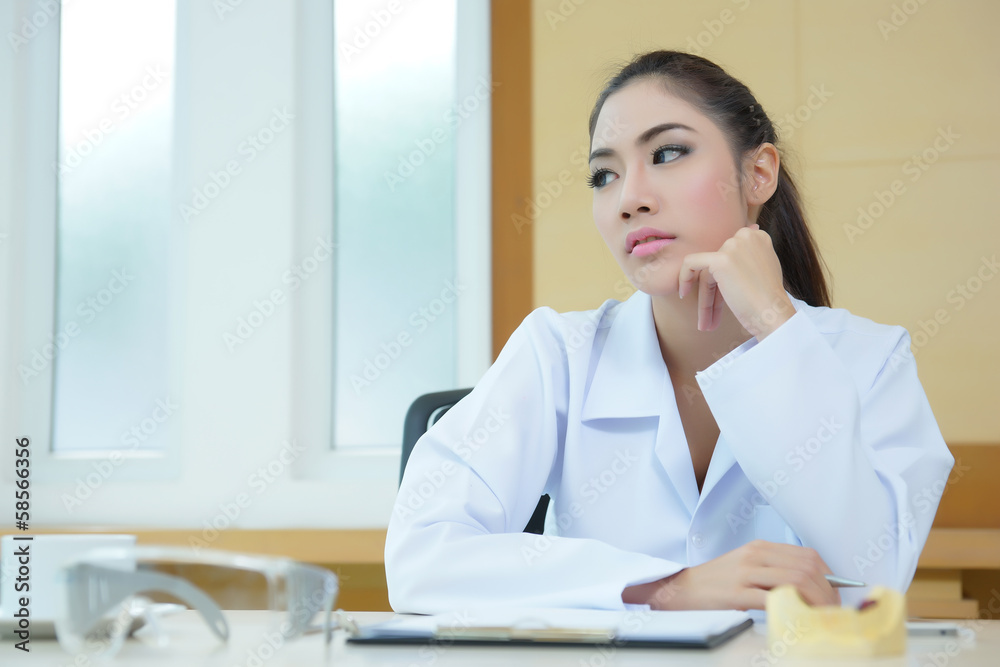 Bored woman dentist looking very boring at her desk Bored woman dentist looking very boring at her desk