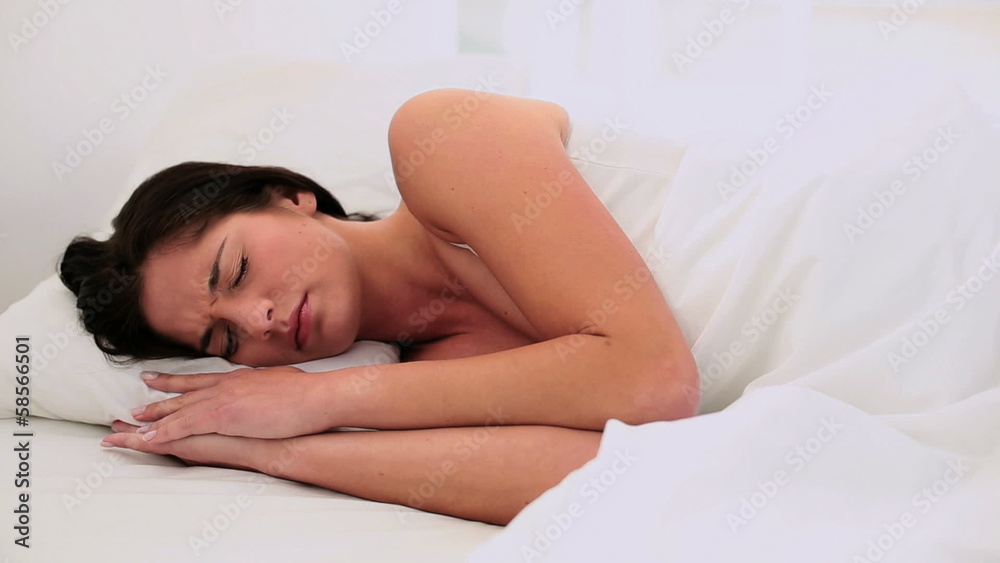 Attractive brunette tossing and turning in bed Attractive brunette tossing and turning in bed