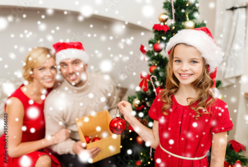 smiling family decorating christmas tree