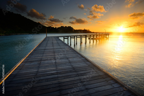 The beautiful wooden pier with sunrise at Rayong, Thailand