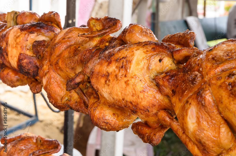 Naklejka premium Grilled chicken on the spit thai food