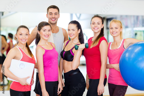group of smiling people in the gym