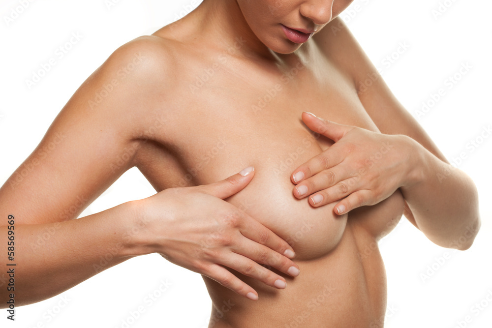 Woman manipulating her breast in a cancer check Woman manipulating her breast in a cancer check