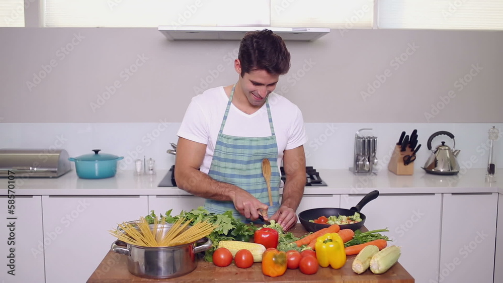 Handsome man chopping vegetables Handsome man chopping vegetables