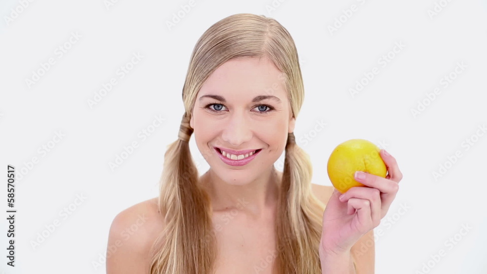 Happy nude blonde holding orange Happy nude blonde holding orange