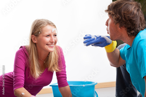 Couple having fun during cleaning photo
