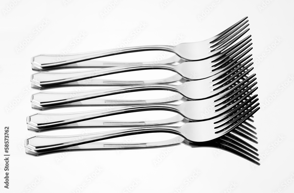 Set of stainless steel fork reflection on white background Set of stainless steel fork reflection on white background
