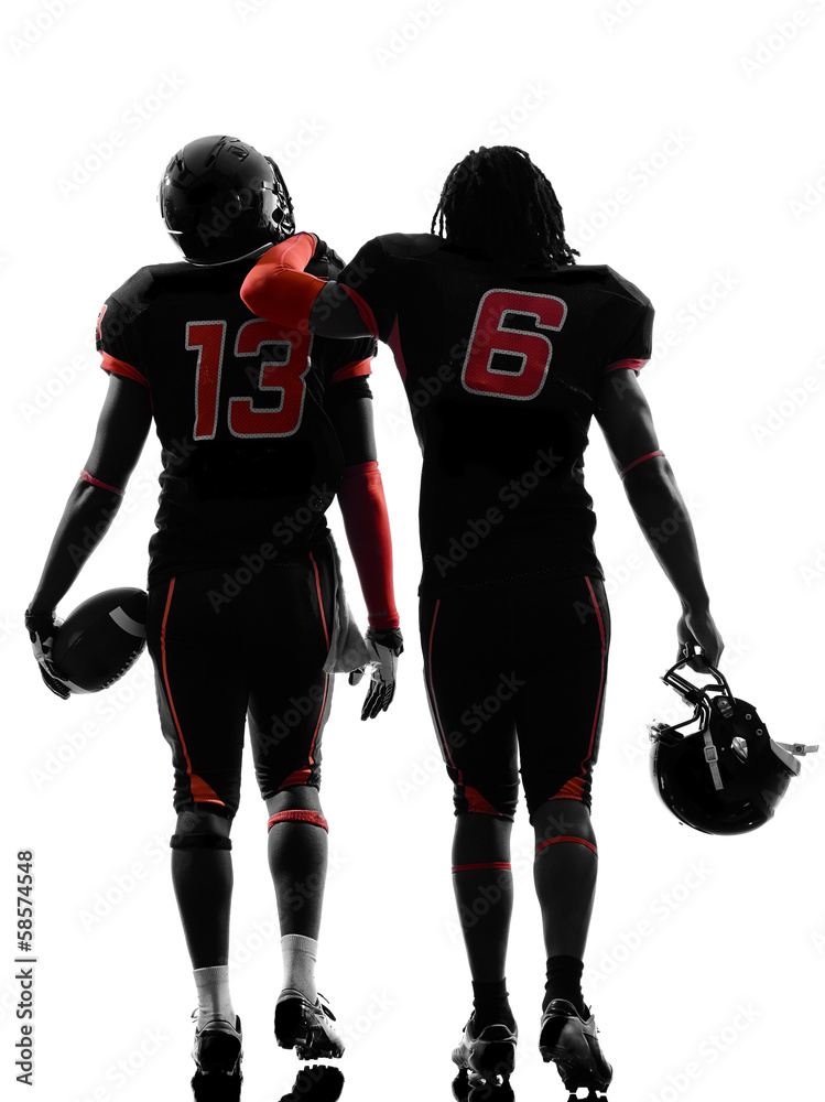 Obraz premium two american football players walking rear view silhouette