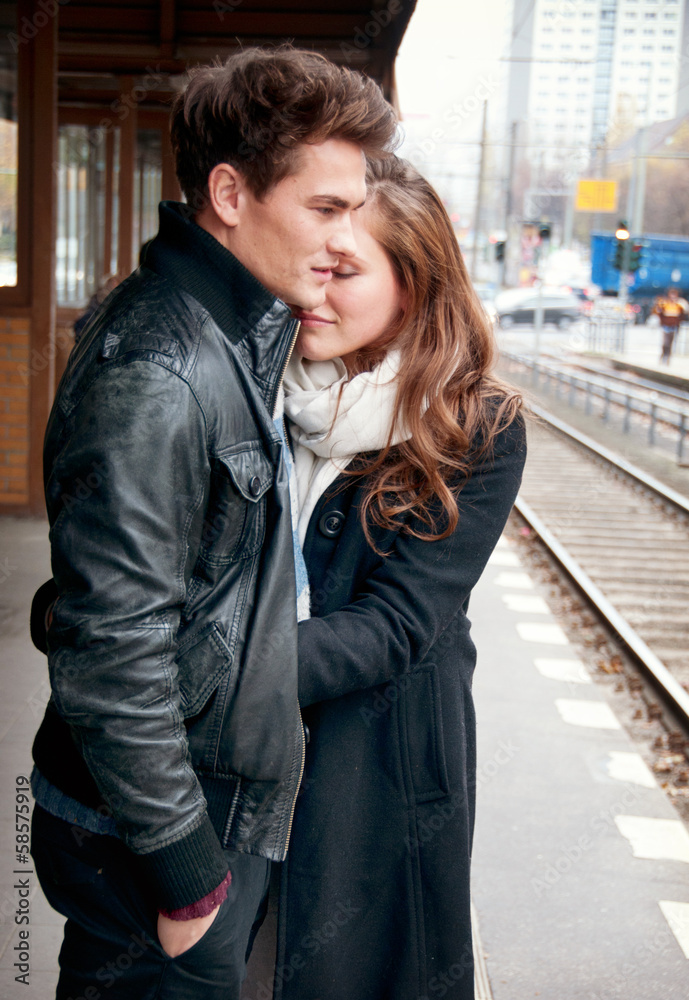 Young love couple waiting on the train stop