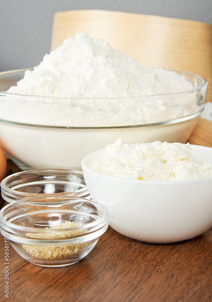 Flour, cottage cheese, sesame on a table