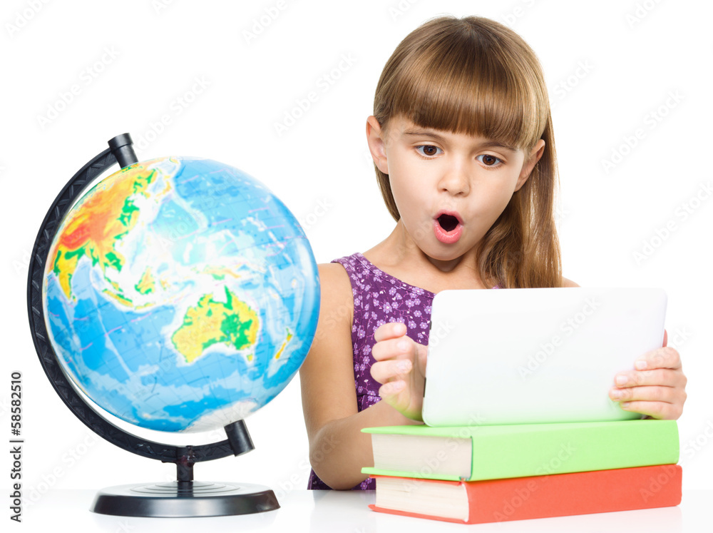 Young girl is using tablet while studying Young girl is using tablet while studying