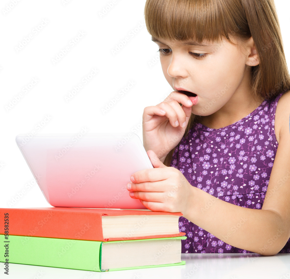 Young girl is using tablet while studying Young girl is using tablet while studying