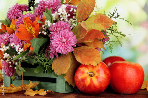 Fototapeta Naklejka Na Ścianę i Meble -  Flowers composition in crate with apples
