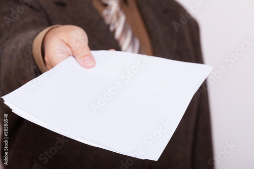 Businessman holding blank sheet of paper. Business concept.