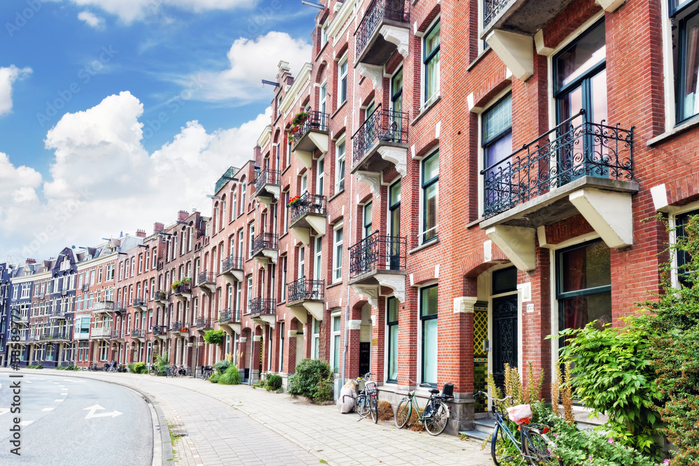 Amsterdam and typical houses with clear summer sky.Netherlands