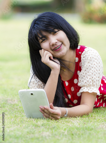 Young woman using her tablet pc photo