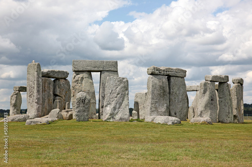 Stonehenge historic site on green grass under blue sky. Stonehen photo