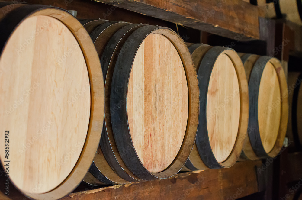 Wine barrels stacked in the cellar.