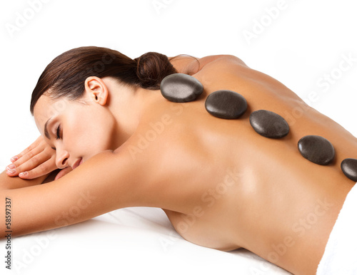 Stone Massage. Beautiful Woman Getting Spa Hot Stones Massage