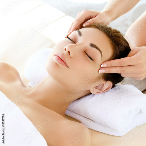 Face Massage. Close-up of a Young Woman Getting Spa Treatment.