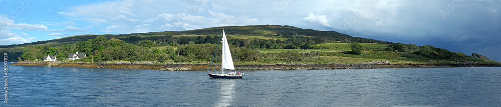 Obraz premium sailboat on a Scottish loch, beautiful hills in background