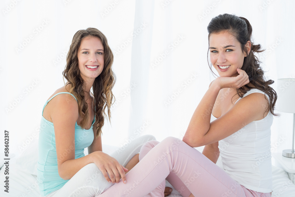 Portrait of happy young female friends on bed Portrait of happy young female friends on bed