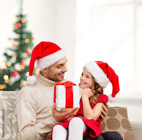 smiling father giving daughter gift box