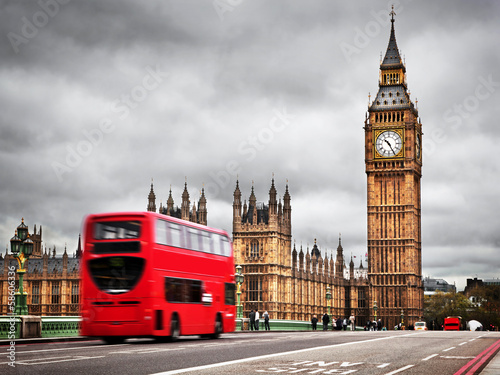 London  the UK. Red bus in motion and Big Ben