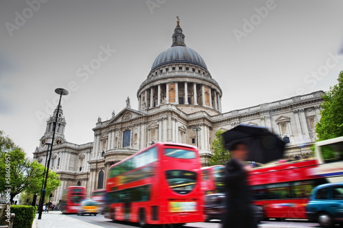 St Paul's Cathedral in London, the UK. Red buses in motion