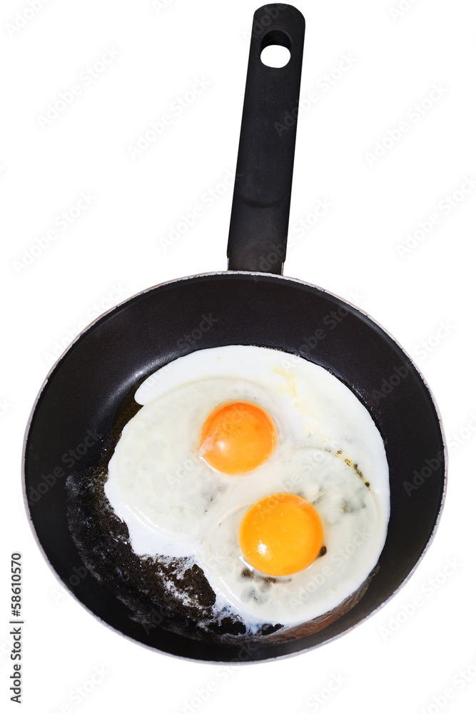 fried eggs in frying pan isolated on white fried eggs in frying pan isolated on white