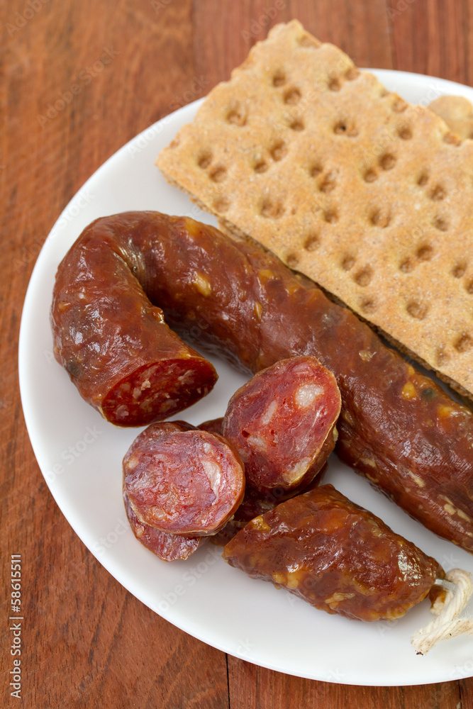 chorizo with toasts on plate