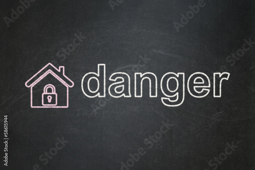 Protection concept  Home and Danger on chalkboard background
