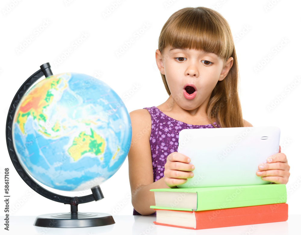 Young girl is using tablet while studying Young girl is using tablet while studying