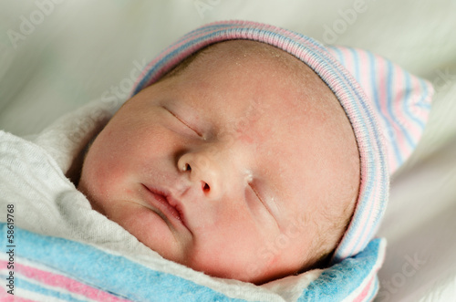 Portrait of swaddled infant moments after birth at hospital