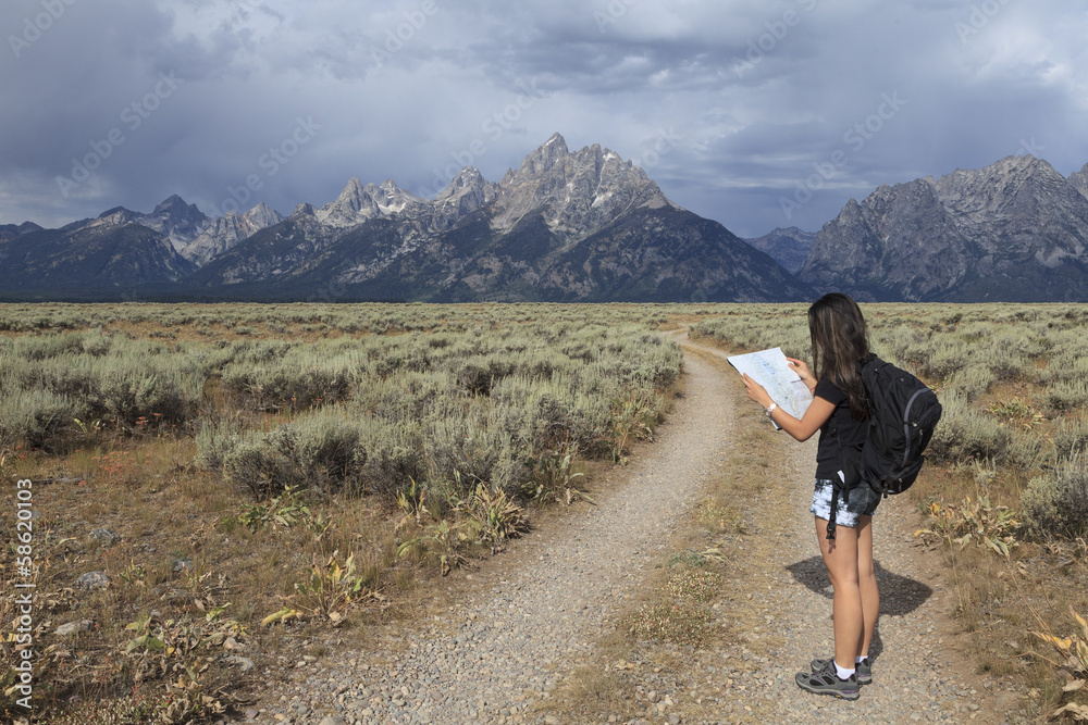 Fototapeta premium Girl reading map in Grand Teton National Park