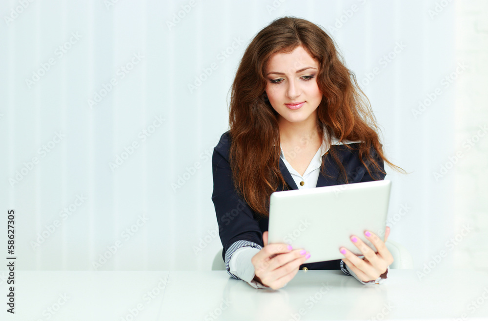 Happy young businesswoman sitting at the table Happy young businesswoman sitting at the table