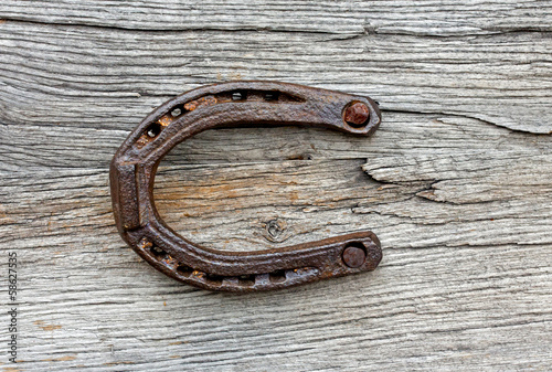 Old horseshoe on the wooden background